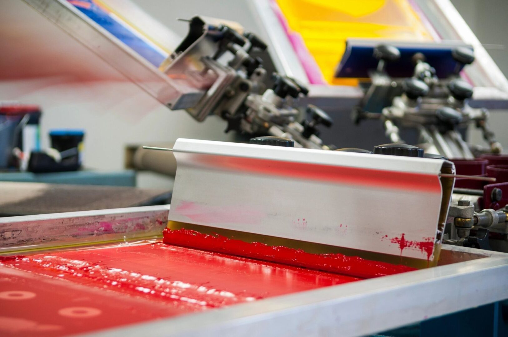 A machine is printing red ink on paper.