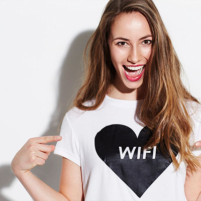 A woman in white shirt with black heart on it.