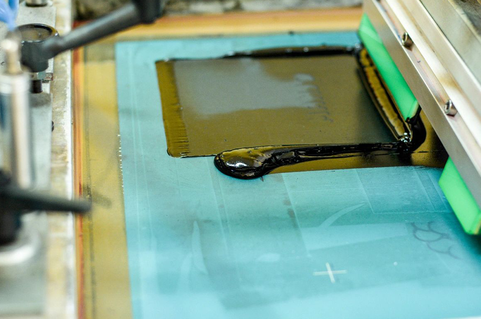 A screen printing press with ink on it