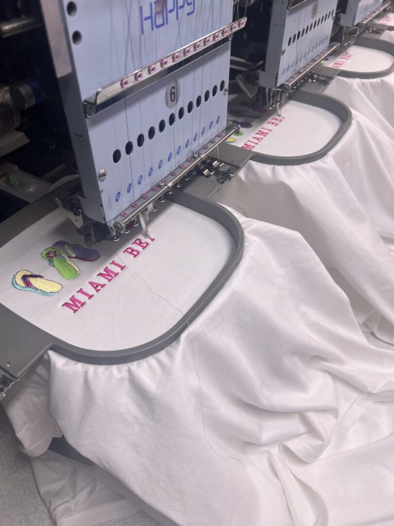 A machine is being used to embroider shirts.