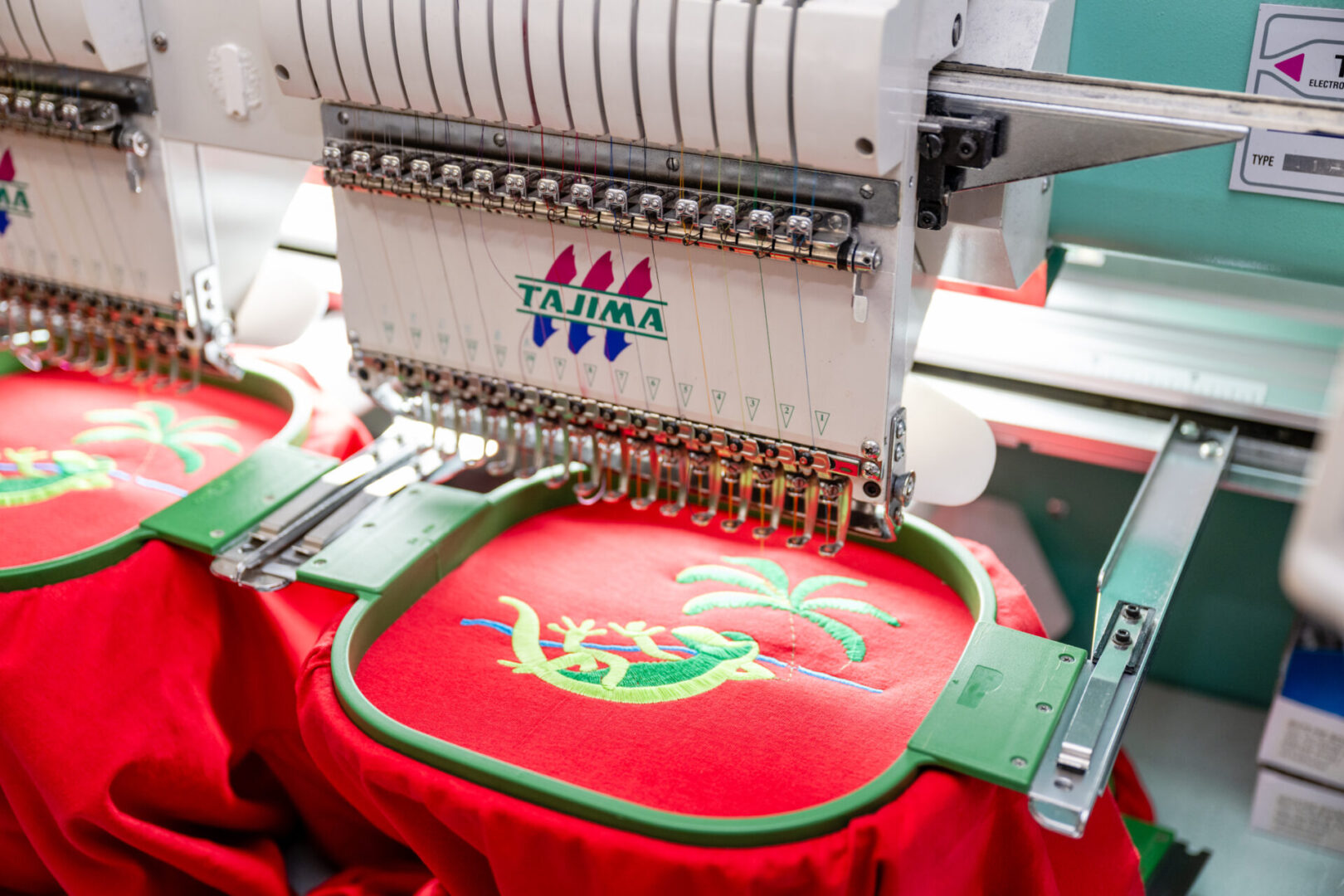 A machine is working on a red cloth.