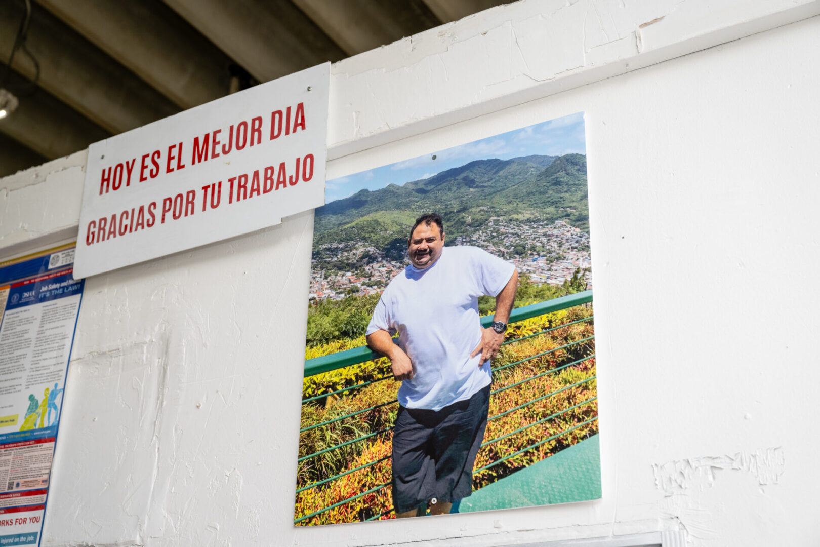 A picture of a man hanging on the side of a building.