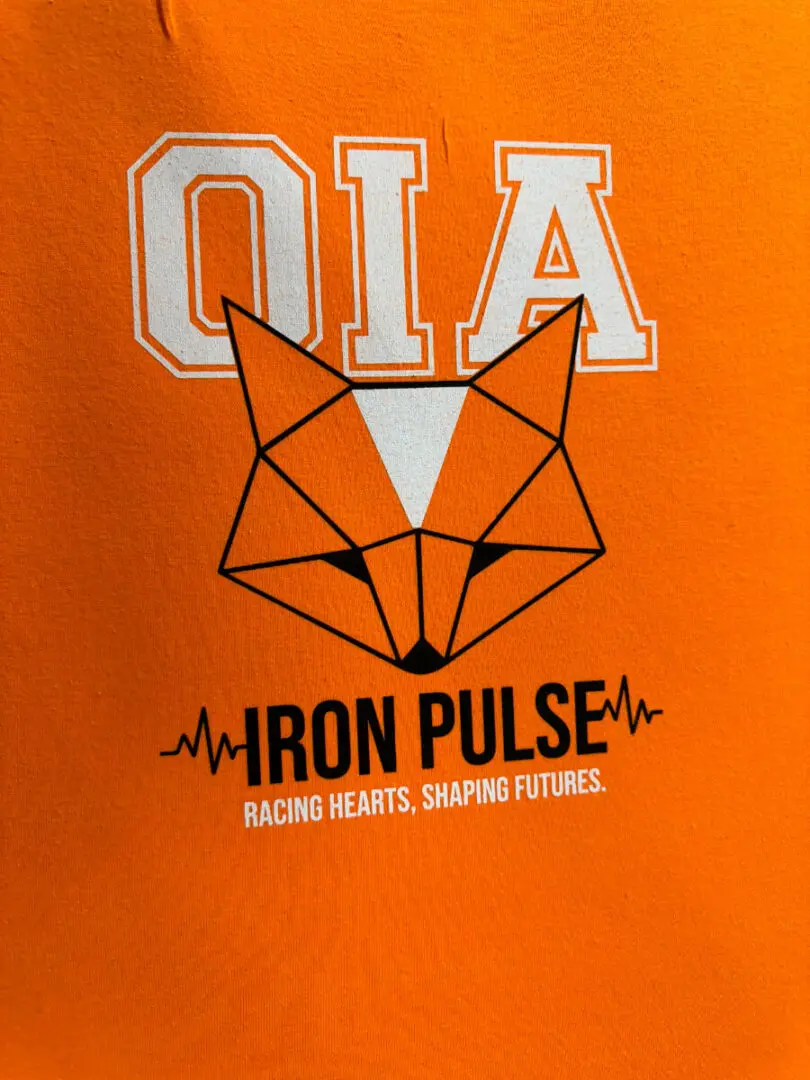 A close up of an orange shirt with the words iron pulse on it