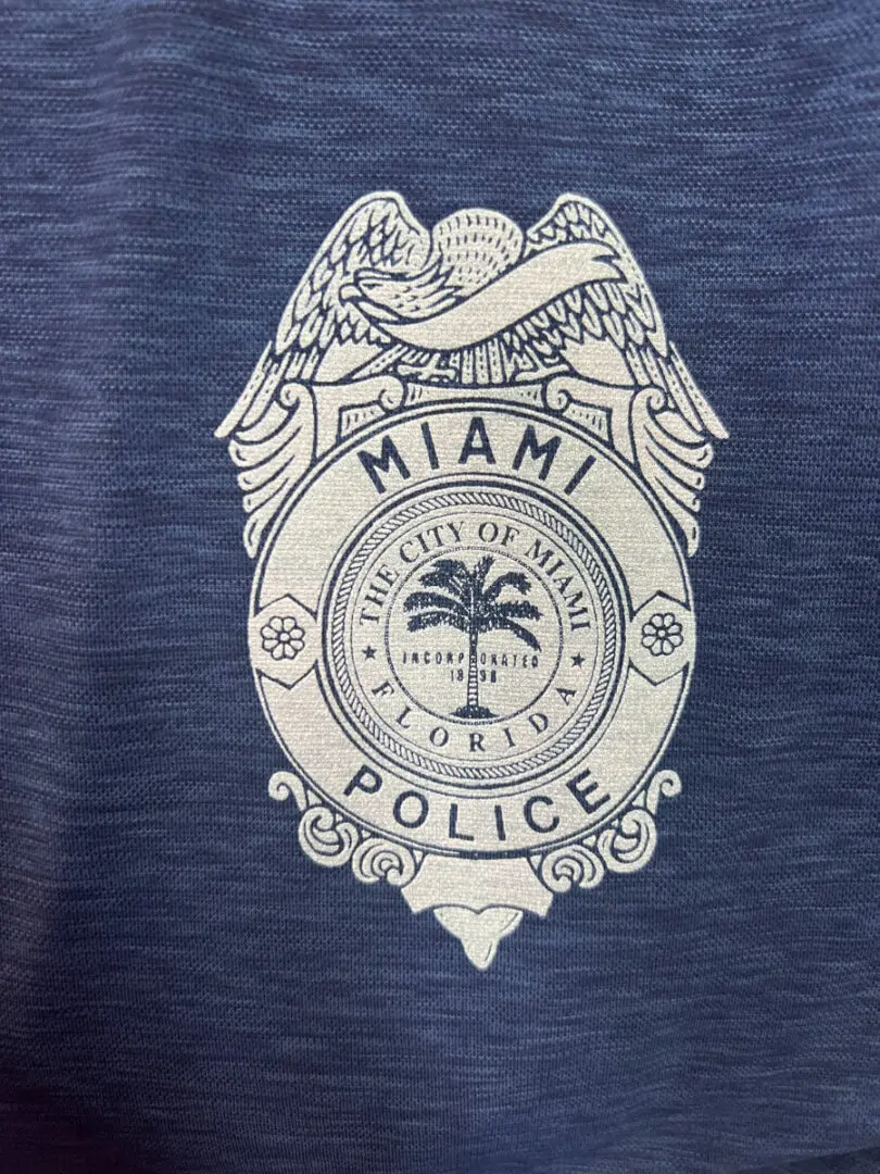 A police badge on the chest of a t-shirt.