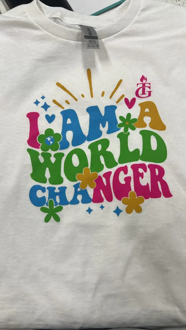 A white shirt that says i am a world changer.